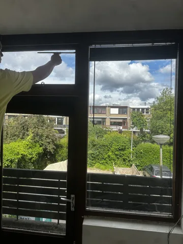 Reinigingswerk aan een raamkozijn